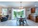 Cozy dining area features a round table, backyard access, and is open to the kitchen at 12208 Mcmullen Loop, Riverview, FL 33569