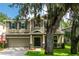 Two-story home with a two-car garage, neutral siding, black shutters and a lovely lawn at 12208 Mcmullen Loop, Riverview, FL 33569