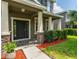 Inviting home entrance with stacked stone accents on columns and fresh landscaping at 12208 Mcmullen Loop, Riverview, FL 33569