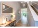 Inviting hallway leading to the dining room and featuring a staircase with a stylish console table at 12208 Mcmullen Loop, Riverview, FL 33569