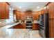 Stylish kitchen features granite countertops and stainless steel appliances, and plenty of storage space at 12208 Mcmullen Loop, Riverview, FL 33569