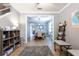 Open-concept living area with gray walls and tile floors transitions to formal dining room at 12208 Mcmullen Loop, Riverview, FL 33569