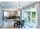 View from breakfast nook into open living area and out sliding doors to backyard at 12208 Mcmullen Loop, Riverview, FL 33569
