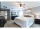 Spacious main bedroom features a ceiling fan, a king bed, and an ensuite bathroom at 12208 Mcmullen Loop, Riverview, FL 33569