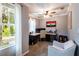 Well-lit home office with desk, chair, and large window showcasing outdoor views at 12208 Mcmullen Loop, Riverview, FL 33569