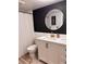 Modern bathroom featuring a vanity with a gold framed circular mirror and a shower at 1221 Drew St # C2, Clearwater, FL 33755