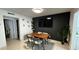 Dining area with modern table and chairs next to a living area at 1221 Drew St # C2, Clearwater, FL 33755