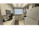 Galley kitchen with modern appliances, ample counter space, and bright lighting at 1221 Drew St # C2, Clearwater, FL 33755