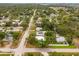 The aerial perspective captures the home’s setting in a residential area, illustrating its neighborhood and surrounding foliage at 1242 74Th N St, St Petersburg, FL 33710