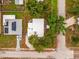 Aerial view showing the home's layout and surrounding mature trees at 1242 74Th N St, St Petersburg, FL 33710