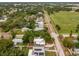 An aerial view of a neighborhood street, showcasing the surrounding greenery, a park, and neighboring homes at 1242 74Th N St, St Petersburg, FL 33710