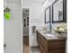 Modern bathroom with a double sink vanity, wooden cabinets, and granite countertops at 1242 74Th N St, St Petersburg, FL 33710