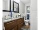 Modern bathroom with a double sink vanity, wooden cabinets, and granite countertops at 1242 74Th N St, St Petersburg, FL 33710