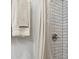 Bathroom shower with modern white herringbone tiling and sleek fixtures and soft towels at 1242 74Th N St, St Petersburg, FL 33710