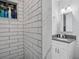 Modern bathroom featuring sleek white subway tile, granite countertop vanity, and shower niche at 1242 74Th N St, St Petersburg, FL 33710