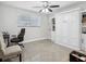 Cozy bedroom with a Murphy bed, ceiling fan, and built-in shelving for storage at 1242 74Th N St, St Petersburg, FL 33710