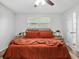 Bedroom featuring a comfortable bed, ceiling fan, and a doorway leading to another room at 1242 74Th N St, St Petersburg, FL 33710