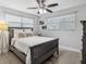 Comfortable bedroom featuring a full bed, two windows, and a modern ceiling fan at 1242 74Th N St, St Petersburg, FL 33710
