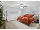 Bedroom with a large window, ceiling fan, and stylish bed with orange bedding at 1242 74Th N St, St Petersburg, FL 33710