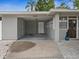 Carport showing access to the main house, a covered parking space, and front yard details at 1242 74Th N St, St Petersburg, FL 33710