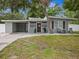 Charming single-story home featuring neutral paint, covered parking, and a quaint front yard at 1242 74Th N St, St Petersburg, FL 33710
