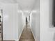 Long hallway with wood flooring, leading to other rooms in the home at 1242 74Th N St, St Petersburg, FL 33710