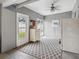 Light-filled sunroom with gray walls, diamond-patterned rug, and access to the backyard at 1242 74Th N St, St Petersburg, FL 33710