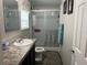 Clean and modern bathroom with a sliding glass door shower and updated fixtures at 12426 Terra Ceia Ave, New Port Richey, FL 34654