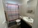 Bathroom with a white sink, patterned shower curtain, and neutral-toned walls at 12426 Terra Ceia Ave, New Port Richey, FL 34654