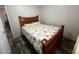 Cozy bedroom features a floral bedspread and wood-look floors at 12426 Terra Ceia Ave, New Port Richey, FL 34654