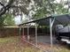 Metal carport with a boat covered by a gray tarp at 12426 Terra Ceia Ave, New Port Richey, FL 34654