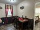 Dining area with a dark wood table, seating for six, and modern decor at 12426 Terra Ceia Ave, New Port Richey, FL 34654
