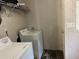 The laundry room has white appliances and a wire shelf at 12426 Terra Ceia Ave, New Port Richey, FL 34654