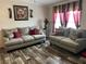 Inviting living room with comfortable sofas, modern flooring, and decorative accents at 12426 Terra Ceia Ave, New Port Richey, FL 34654