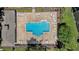 Aerial view of the community pool surrounded by lounge chairs and a privacy fence at 12437 Foxmoor Peak Dr, Riverview, FL 33579