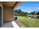Covered back porch with views of a pond, grassy lawn and mature trees at 12437 Foxmoor Peak Dr, Riverview, FL 33579