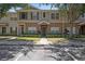 Townhouse exterior featuring neutral colors, manicured landscaping, and well-maintained facade at 12437 Foxmoor Peak Dr, Riverview, FL 33579