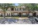 Townhome with neutral paint, green shutters and front-entry door, with reserved parking spaces at 12437 Foxmoor Peak Dr, Riverview, FL 33579
