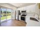 Well-lit kitchen with stainless steel appliances and access to the backyard and pond at 12437 Foxmoor Peak Dr, Riverview, FL 33579