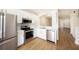 Modern kitchen with white cabinets, quartz countertops, and stainless steel appliances at 12437 Foxmoor Peak Dr, Riverview, FL 33579