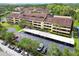 Overhead image of multiple condo buildings with covered parking, lush landscaping, and surrounding trees at 13612 S Village Dr # 5201, Tampa, FL 33618