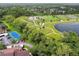 Aerial view of community amenities including tennis courts, walking paths, a park, and a pond at 13612 S Village Dr # 5201, Tampa, FL 33618