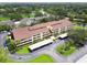 Aerial shot of condo building with covered parking and beautiful greenery; golf course in background at 13612 S Village Dr # 5201, Tampa, FL 33618