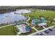 Aerial view of the community park with a splash pad, playground, picnic area, and boardwalk trails around a scenic lake at 13612 S Village Dr # 5201, Tampa, FL 33618