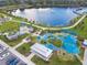 Aerial shot of the community park featuring a splash pad, playground, scenic lake, and wooden boardwalk along the water at 13612 S Village Dr # 5201, Tampa, FL 33618