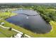 Aerial view showcasing the lake with a curved bridge, walking paths, and lush greenery in the community at 13612 S Village Dr # 5201, Tampa, FL 33618