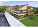 Upper view of condo with mature landscaping, palm trees, covered parking, and manicured walkway at 13612 S Village Dr # 5201, Tampa, FL 33618