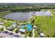 Aerial view showcasing the lake with a curved bridge and a water park at 13612 S Village Dr # 5201, Tampa, FL 33618