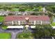 Birds eye view of condo community with tropical landscaping, parking, and surrounding golf course at 13612 S Village Dr # 5201, Tampa, FL 33618