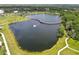 Aerial view showcasing the lake with a curved bridge, walking paths, and lush greenery in the community at 13612 S Village Dr # 5201, Tampa, FL 33618